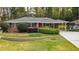 Charming brick home with a well-maintained lawn and beautiful landscaping, perfect for curb appeal at 1323 Christmas Ne Ln, Atlanta, GA 30329