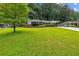 Beautiful, well-manicured front yard leading up to a charming brick home with covered parking at 1323 Christmas Ne Ln, Atlanta, GA 30329
