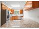 Well-lit kitchen with granite countertops, wood cabinets, stainless steel appliances and a skylight at 1323 Christmas Ne Ln, Atlanta, GA 30329