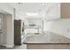 Modern kitchen with stainless steel appliances, white cabinetry, granite countertops, and ample natural light at 1323 Christmas Ne Ln, Atlanta, GA 30329