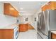 Bright kitchen featuring granite countertops, wooden cabinets, stainless steel refrigerator, and tiled flooring at 1323 Christmas Ne Ln, Atlanta, GA 30329