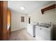 Laundry area with appliances, tile floor, access to backyard at 1323 Christmas Ne Ln, Atlanta, GA 30329
