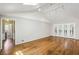 Bright living room showcasing high ceilings, hardwood flooring, and access to the outdoor area at 1323 Christmas Ne Ln, Atlanta, GA 30329