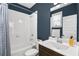 Bathroom with white subway tile surround and dark wood vanity at 2013 Rockledge Ne Rd, Atlanta, GA 30324