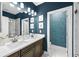 Modern bathroom featuring double sinks, modern lighting, and a glass-door shower at 2013 Rockledge Ne Rd, Atlanta, GA 30324