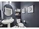 Modern bathroom with a pedestal sink, stylish decor, and dark walls for a contemporary look at 2013 Rockledge Ne Rd, Atlanta, GA 30324