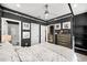 A modern bedroom with a four-poster bed, ceiling fan, and neutral-toned bedding at 2013 Rockledge Ne Rd, Atlanta, GA 30324