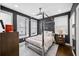Stylish bedroom featuring a unique canopy bed frame, ceiling fan, and dark walls at 2013 Rockledge Ne Rd, Atlanta, GA 30324