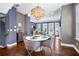 Bright dining area features modern lighting, unique wallpaper, and hardwood floors, ideal for entertaining guests at 2013 Rockledge Ne Rd, Atlanta, GA 30324
