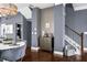 Dining space with elegant decor, a round table, and stairs leading to the upper level, enhanced with blue walls at 2013 Rockledge Ne Rd, Atlanta, GA 30324
