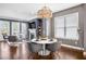 Dining area with ample natural light, elegant lighting, and hardwood floors leading into the living room at 2013 Rockledge Ne Rd, Atlanta, GA 30324