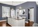 Kitchen island with seating in a well-lit area that boasts modern appliances and neutral paint, ready for entertaining guests at 2013 Rockledge Ne Rd, Atlanta, GA 30324