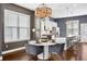 Modern kitchen with a central island, seating, stainless steel appliances, and sleek white cabinetry at 2013 Rockledge Ne Rd, Atlanta, GA 30324