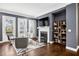 Inviting living room with a cozy fireplace, hardwood floors, and plenty of natural light from the large windows at 2013 Rockledge Ne Rd, Atlanta, GA 30324
