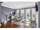 Spacious living room with hardwood floors, modern furniture, a fireplace, and access to outdoor spaces at 2013 Rockledge Ne Rd, Atlanta, GA 30324