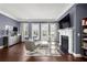 Cozy living room with a fireplace, stylish furniture, hardwood floors, and ample natural light from the windows at 2013 Rockledge Ne Rd, Atlanta, GA 30324