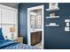 Main bedroom with floating shelves, a window, and doorway to a modern bathroom at 2013 Rockledge Ne Rd, Atlanta, GA 30324