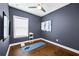Hardwood floor workout room with ceiling fan, natural light, exercise mat and mounted TV at 2013 Rockledge Ne Rd, Atlanta, GA 30324