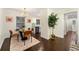 Elegant dining room with hardwood floors, a glass table, and stylish chairs, flowing into the kitchen at 2903 Akron Street, East Point, GA 30344