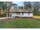 Charming one-story home with a light-colored exterior, a carport, and a well-manicured front yard at 2903 Akron Street, East Point, GA 30344