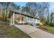 Inviting one-story home with a cozy carport and a walkway leading to the front porch with a blue door at 2903 Akron Street, East Point, GA 30344