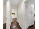 Hallway with hardwood floors, neutral walls, built-in storage, and access to various rooms in the home at 2903 Akron Street, East Point, GA 30344