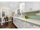 Bright kitchen featuring white cabinetry, a farmhouse sink, quartz countertops, and a stylish backsplash at 2903 Akron Street, East Point, GA 30344