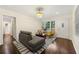 Bright living room with hardwood floors, a comfortable sofa, armchairs, and natural light from the windows at 2903 Akron Street, East Point, GA 30344