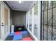 Covered back porch with multicolor floor matting, grill and storage at 64 Saint Claire Ne Ln, Atlanta, GA 30324