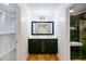 Bright bathroom featuring dual sinks, a black vanity and a large mirror next to a closet and tiled shower at 64 Saint Claire Ne Ln, Atlanta, GA 30324