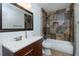 Bathroom featuring a tub-shower combo, tile backsplash, vanity, and mirror at 64 Saint Claire Ne Ln, Atlanta, GA 30324