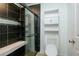 Bathroom featuring a modern tiled shower with a glass door and a sleek toilet with built in shelving at 64 Saint Claire Ne Ln, Atlanta, GA 30324