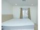 Bright bedroom showcasing a window and a large bed with a buttoned headboard and white mattress at 64 Saint Claire Ne Ln, Atlanta, GA 30324