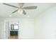 Bedroom featuring ceiling fan, hardwood floors and view to the bathroom, blending comfort and style at 64 Saint Claire Ne Ln, Atlanta, GA 30324