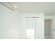 Minimalist bedroom features white walls, bi-fold closet doors, and neutral decor at 64 Saint Claire Ne Ln, Atlanta, GA 30324