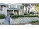 Attractive exterior with a gray stucco facade and well-maintained landscaping and retaining wall at 64 Saint Claire Ne Ln, Atlanta, GA 30324