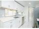 Charming kitchen featuring white cabinets, stainless steel appliances, and tiled floors, offering a clean and modern aesthetic at 64 Saint Claire Ne Ln, Atlanta, GA 30324