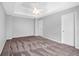 Spacious carpeted bedroom with a tray ceiling and two closets at 2760 Carolina Rdg, Riverdale, GA 30296