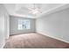 Carpeted bedroom featuring a tray ceiling and lots of natural light at 2760 Carolina Rdg, Riverdale, GA 30296