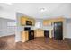 Eat-in kitchen featuring wood cabinets, black appliances, and hardwood flooring at 2760 Carolina Rdg, Riverdale, GA 30296