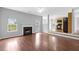 Open floor plan with fireplace, ceiling fan, and hardwood floors leading to kitchen at 2760 Carolina Rdg, Riverdale, GA 30296