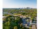 Aerial view of a residential area shows tree-lined streets and the distant skyline of a vibrant city at 399 Se Skylar Way, Atlanta, GA 30315