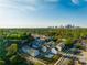 A vibrant community of townhomes nestled among lush greenery, with a skyline view in the distance at 399 Skylar Way, Atlanta, GA 30315