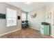Well-lit bedroom with multiple windows, blue desk and matching blue retro mini-fridge at 399 Se Skylar Way, Atlanta, GA 30315