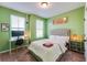 Cozy bedroom with a neutral toned tufted headboard and bright light from the windows at 399 Se Skylar Way, Atlanta, GA 30315