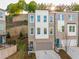 Modern townhome features a brick facade, symmetrical windows, a front-entry garage, and professional landscaping at 399 Se Skylar Way, Atlanta, GA 30315