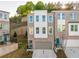 A modern three-story townhome with a painted brick facade and an attached garage at 399 Skylar Way, Atlanta, GA 30315