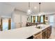 Open kitchen with a large island, stainless steel sink, and a view into the living space at 399 Se Skylar Way, Atlanta, GA 30315