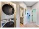 Hallway with stacked washer and dryer along with a view to an adjacent bathroom and bedroom at 399 Se Skylar Way, Atlanta, GA 30315