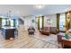 Open-concept living room with a hardwood flooring and views of the stairway and kitchen at 399 Se Skylar Way, Atlanta, GA 30315
